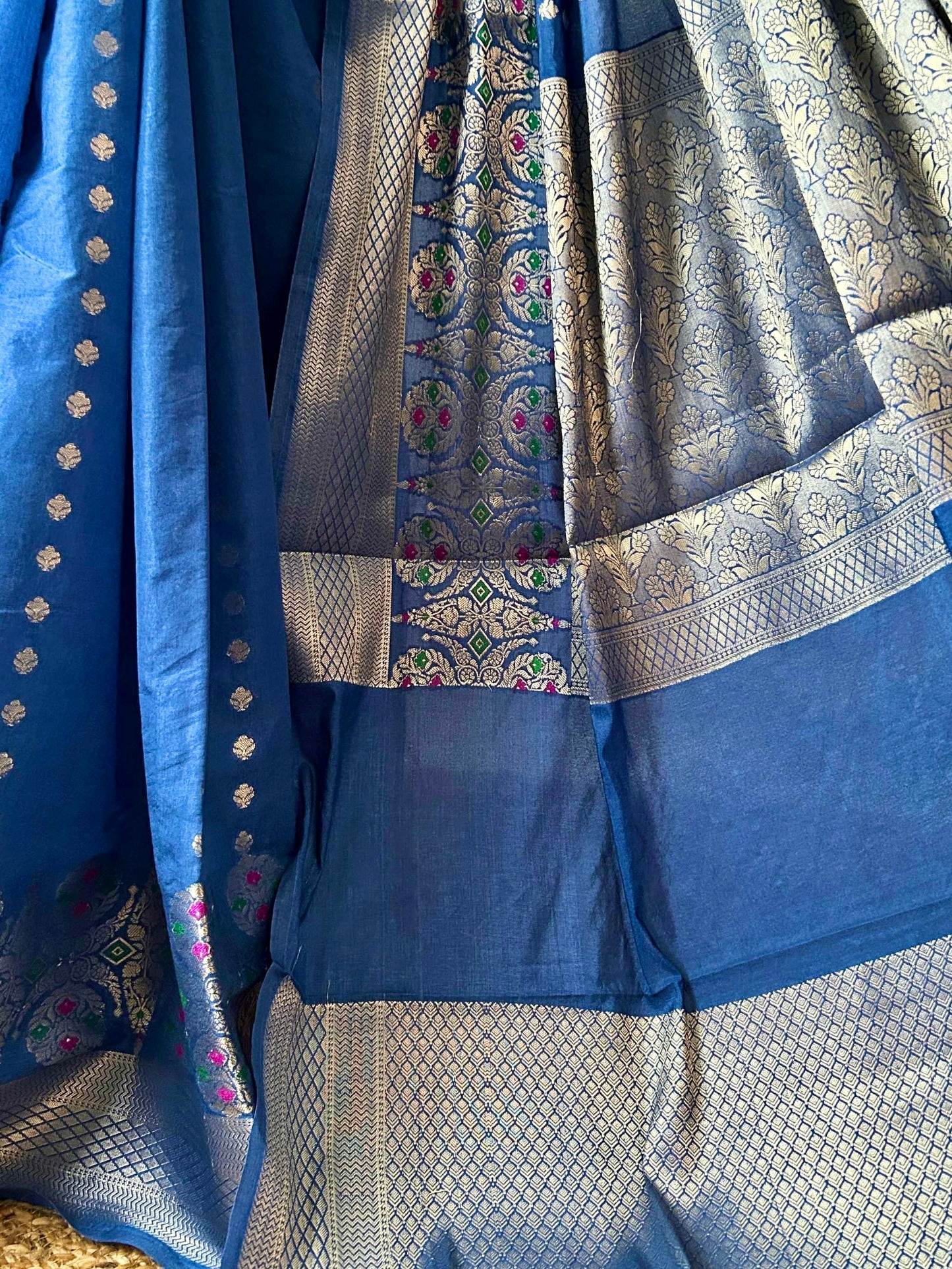 Silver zari meenakari woven pallu and border detail on blue Banarasi saree