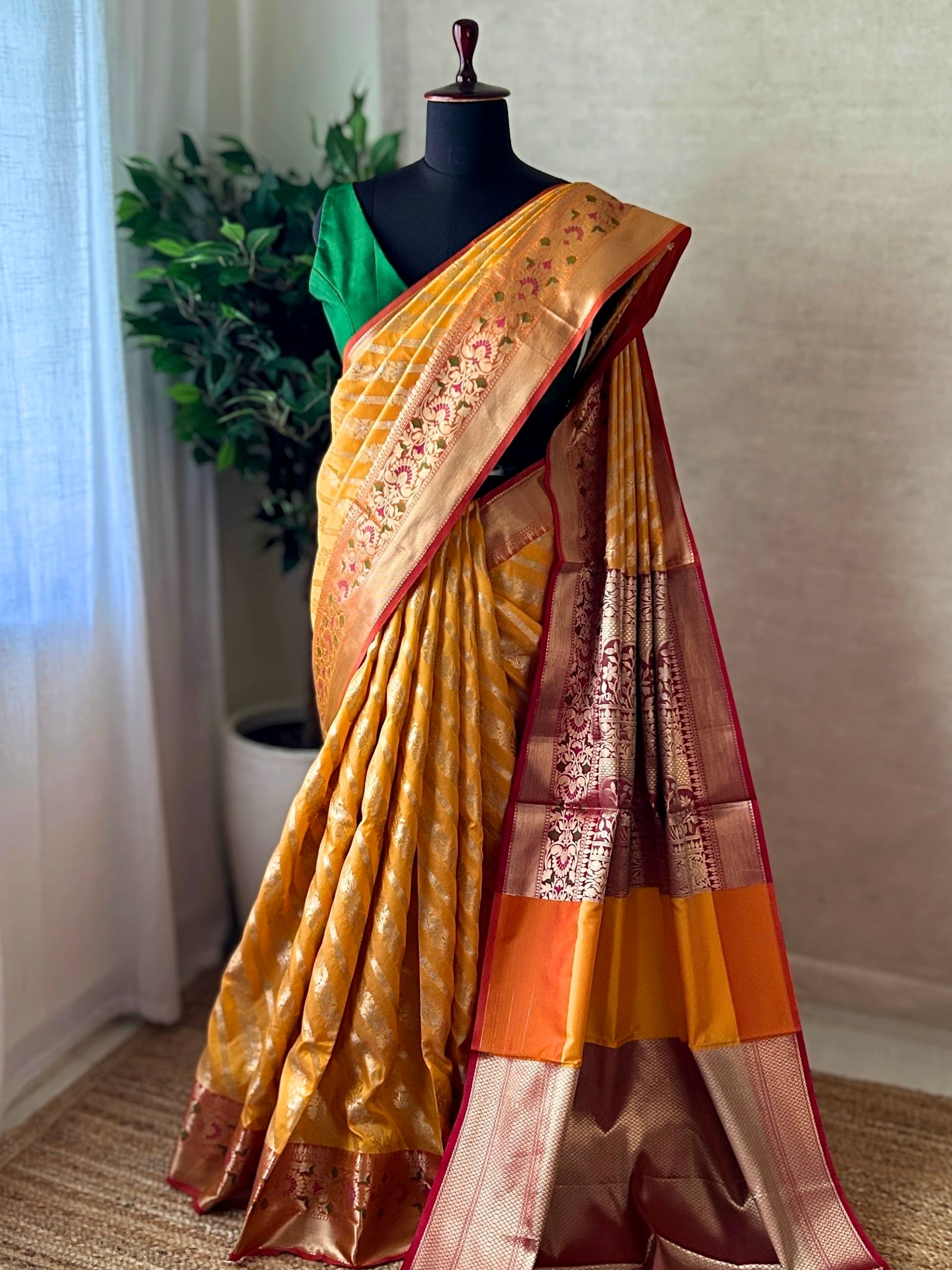 Full drape of orange yellow Katan Banarasi saree with rich pallu